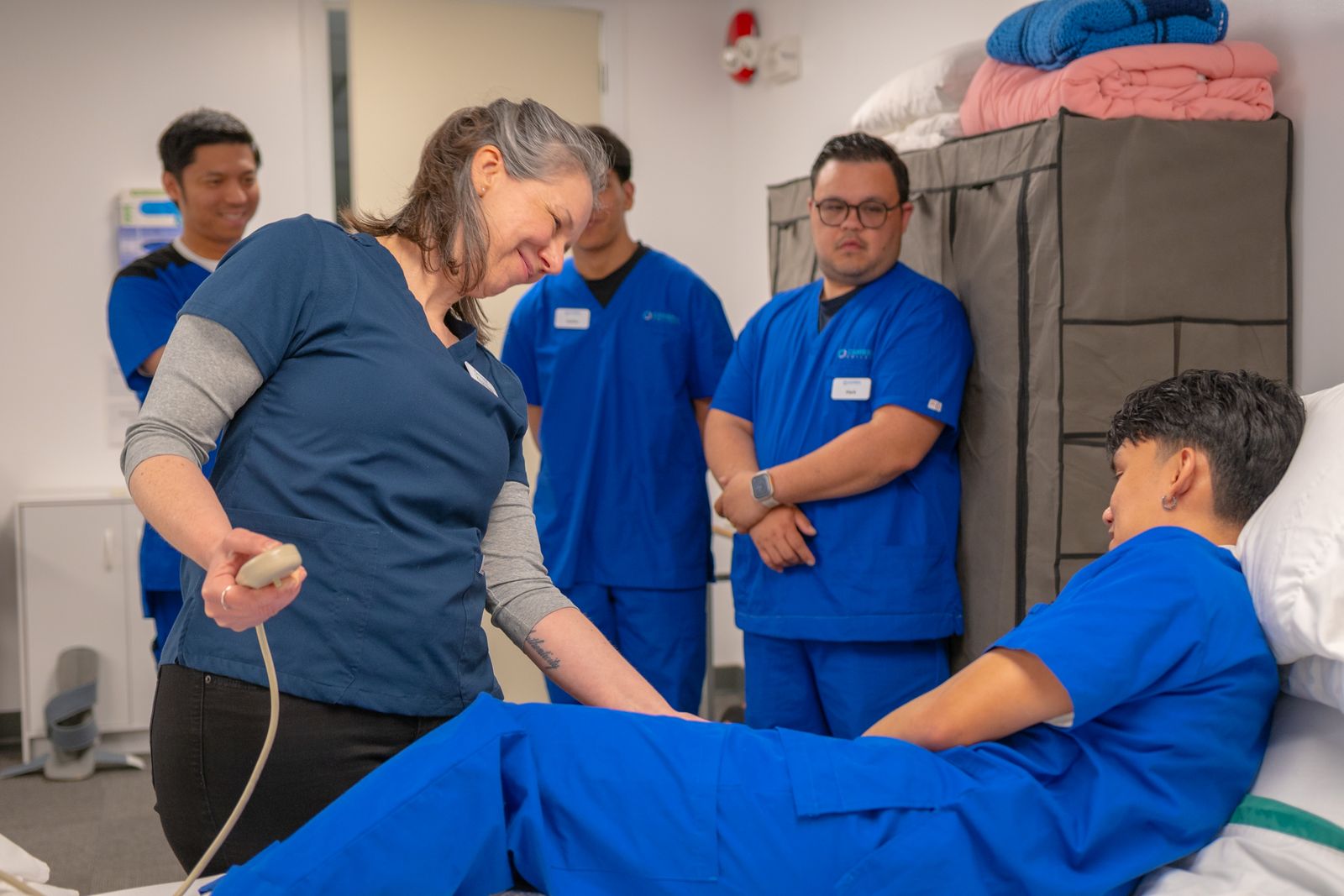 An instructor supervising hands-on clinical training